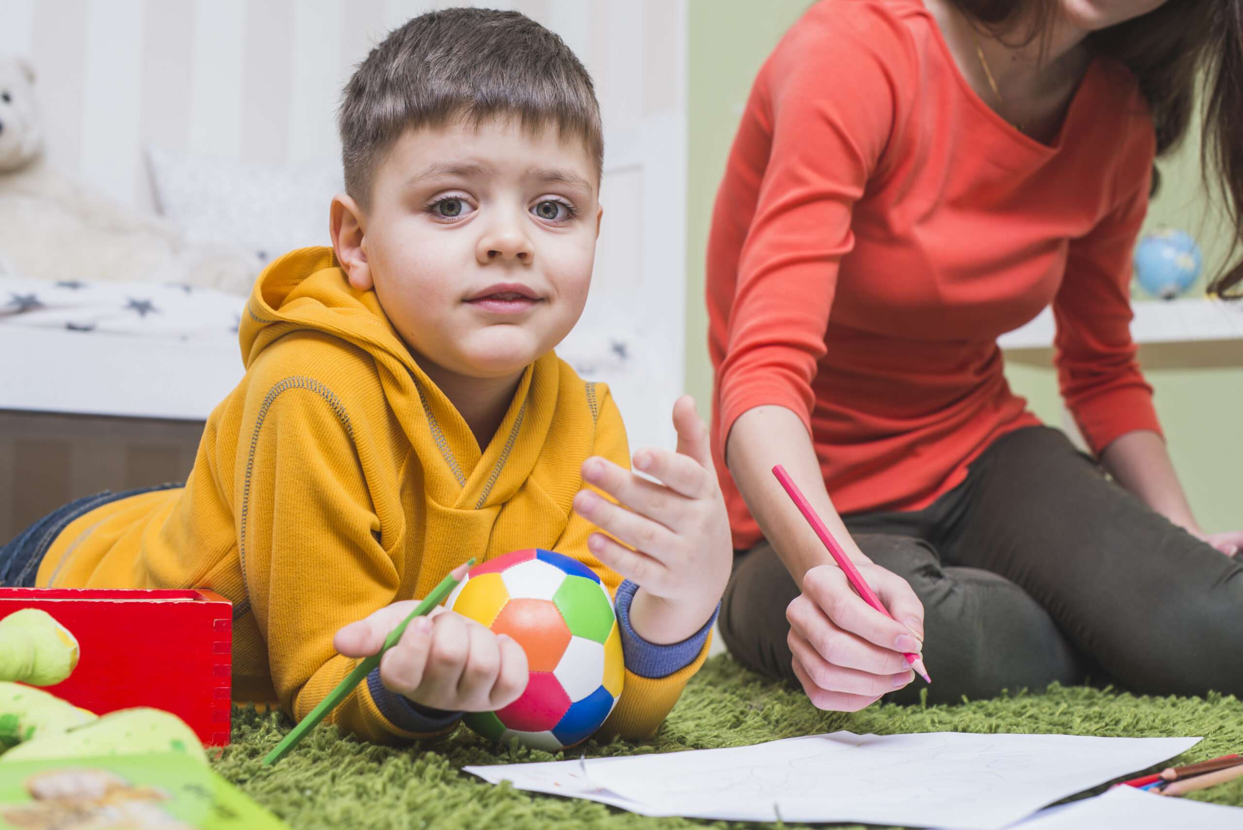 Child drawing with coloured pencils during a calm activity